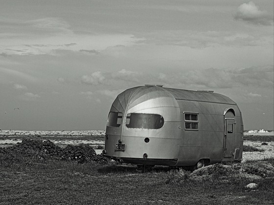 Travel trailer on Dungeness shingle headland, England,  has a California License plate; May 1, 2012